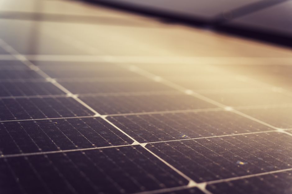 Sun shining brightly over a residential solar panel array